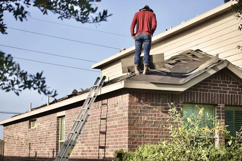 Professional roofer working on a residential roof in Velpoe